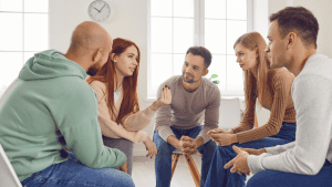 People sitting together in a circle during Group Therapy